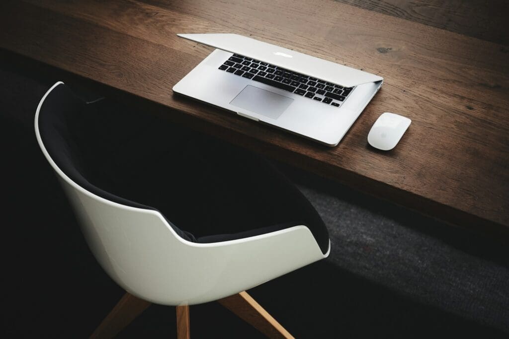 stock image of laptop on desk with chair